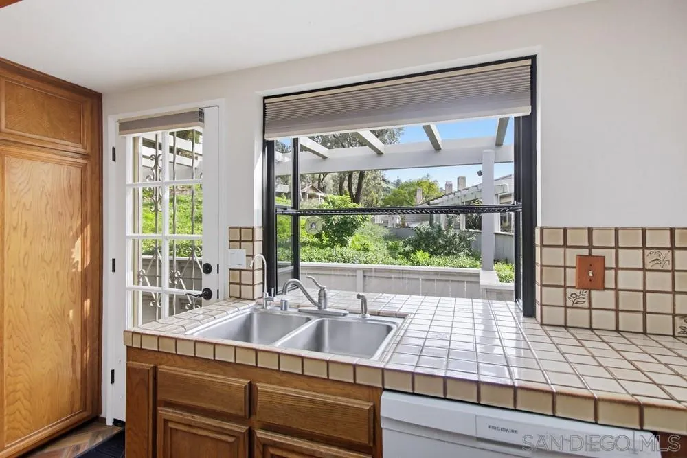 5571 Adobe Falls Road, Unit D San Diego, CA 92120 - Photo 26 of 60 a view of a large window with an outdoor space