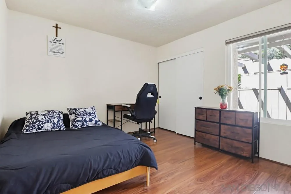 5571 Adobe Falls Road, Unit D San Diego, CA 92120 - Photo 33 of 60 a bed room with a bed dresser and a chair