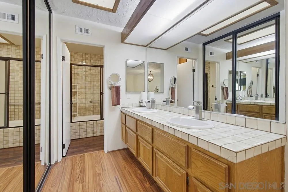 5571 Adobe Falls Road, Unit D San Diego, CA 92120 - Photo 38 of 60 a spacious bathroom with a shower and a sink