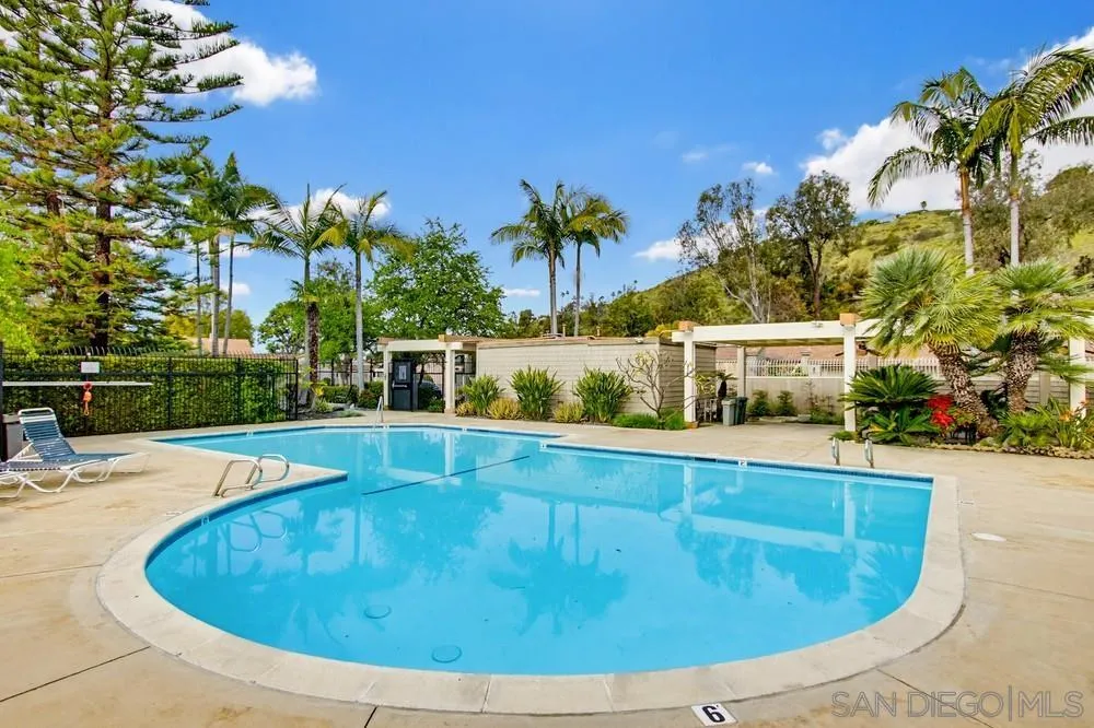 5571 Adobe Falls Road, Unit D San Diego, CA 92120 - Photo 8 of 60 a view of a swimming pool with an outdoor space and seating area
