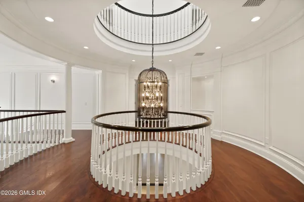 a view of entryway with a table and wooden floor