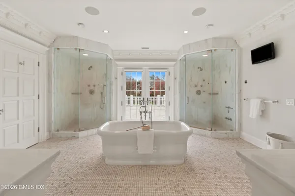 a large bathroom with a shower and a sink