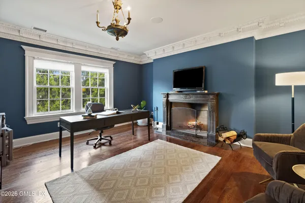 a living room with furniture a flat screen tv and a fireplace