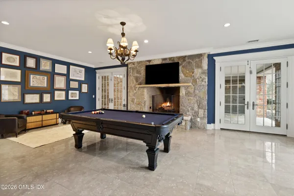 a living room with furniture a piano and a flat screen tv