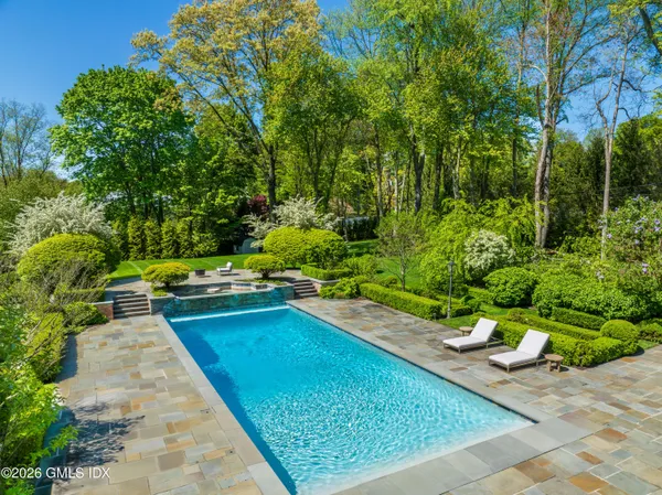 a view of a backyard with swimming pool