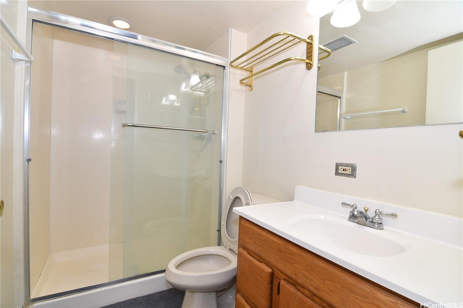 3161 Ala Ilima Street, Unit 202 Honolulu, HI 96818 - Photo 12 of 18 a bathroom with a granite countertop sink toilet and shower