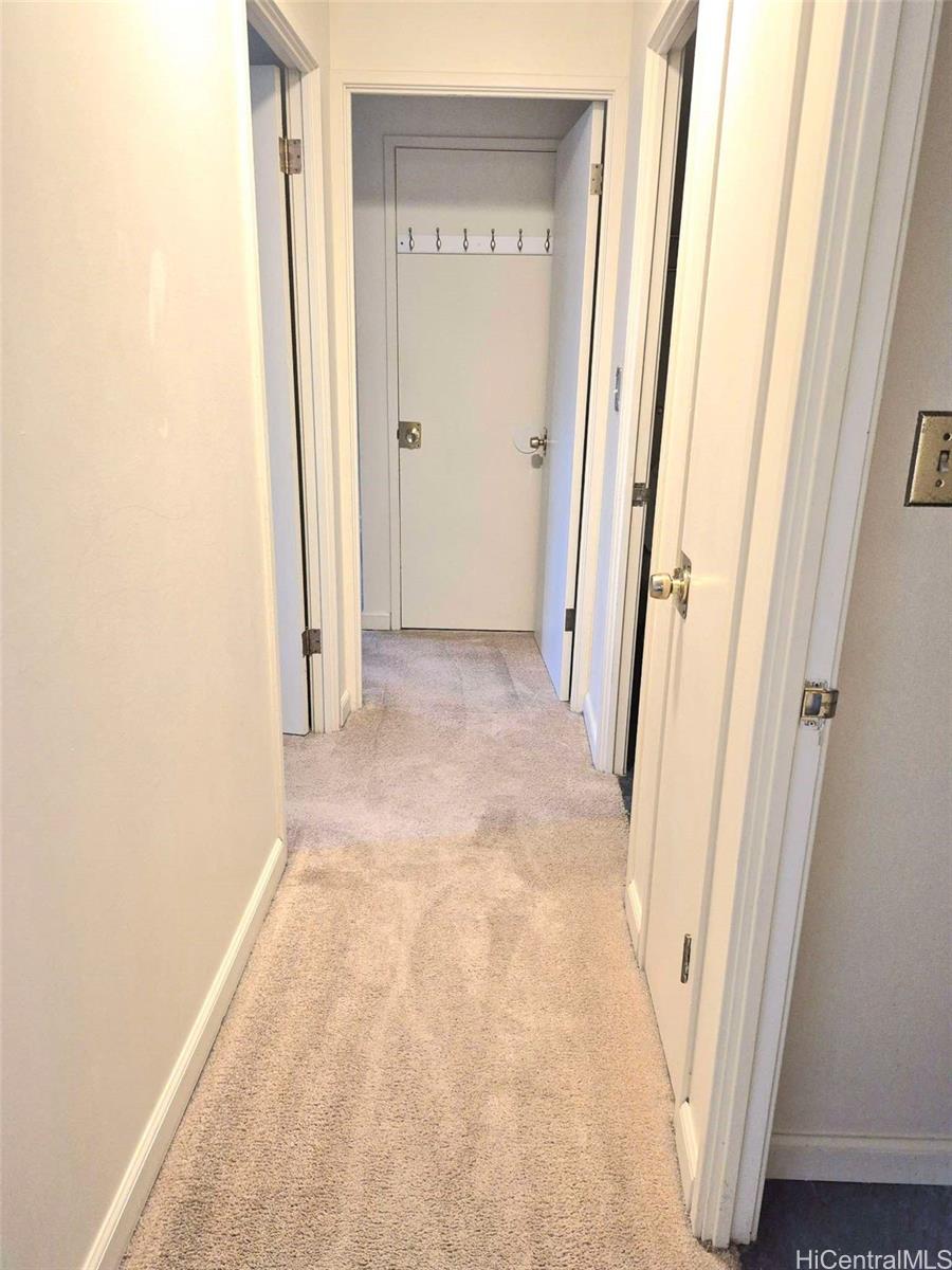 3161 Ala Ilima Street, Unit 202 Honolulu, HI 96818 - Photo 13 of 18 a view of a hallway with wooden floor