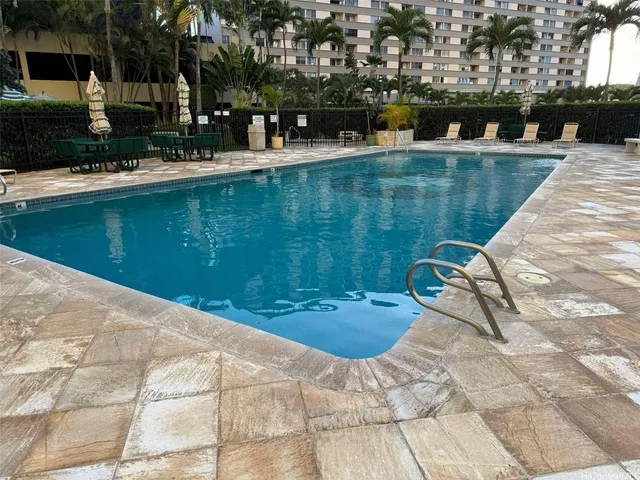 a view of swimming pool with outdoor seating and plants