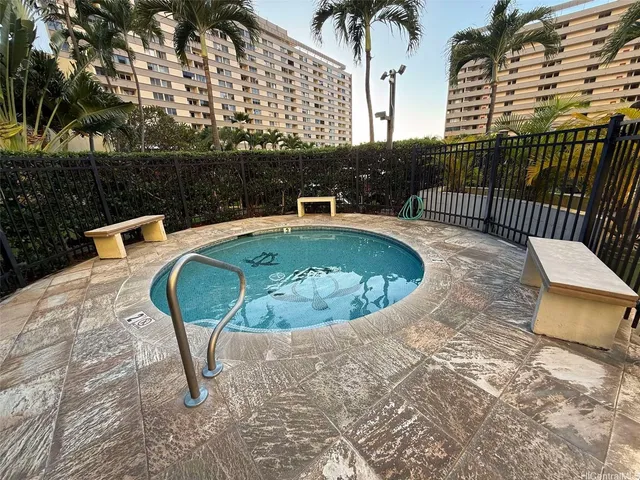 a view of a swimming pool with a patio and a yard