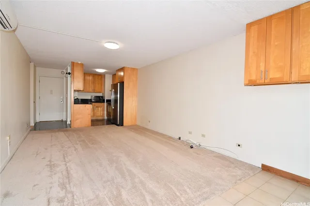 a view of a kitchen with a sink and a refrigerator