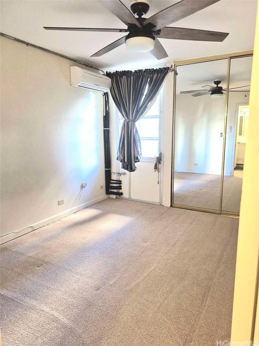 3161 Ala Ilima Street, Unit 202 Honolulu, HI 96818 - Photo 10 of 18 an empty room with a ceiling fan and window