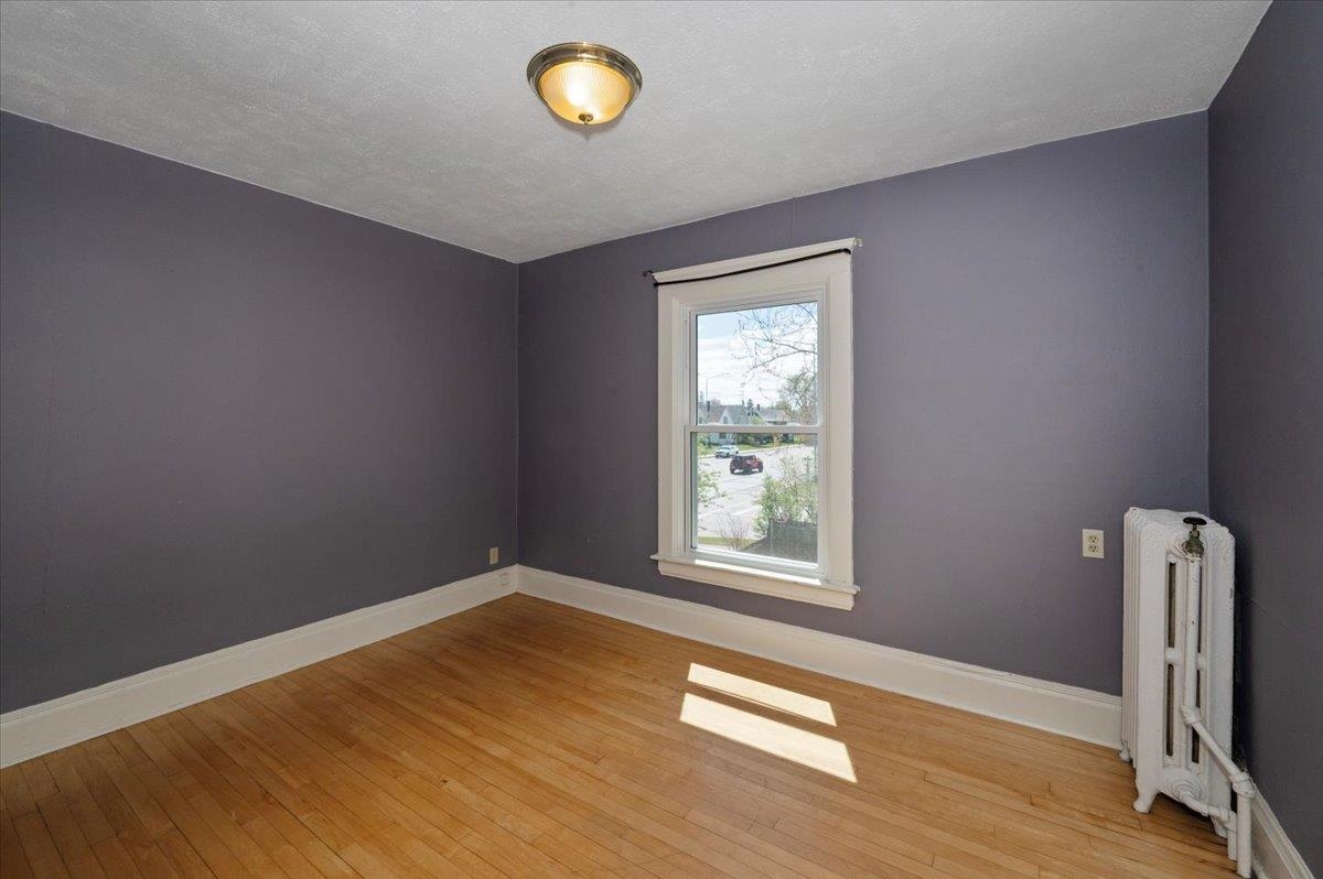 2127 Tower Avenue Superior, WI 54880 - Photo 21 of 39 Spare room with radiator heating unit, light wood-style floors, and baseboards