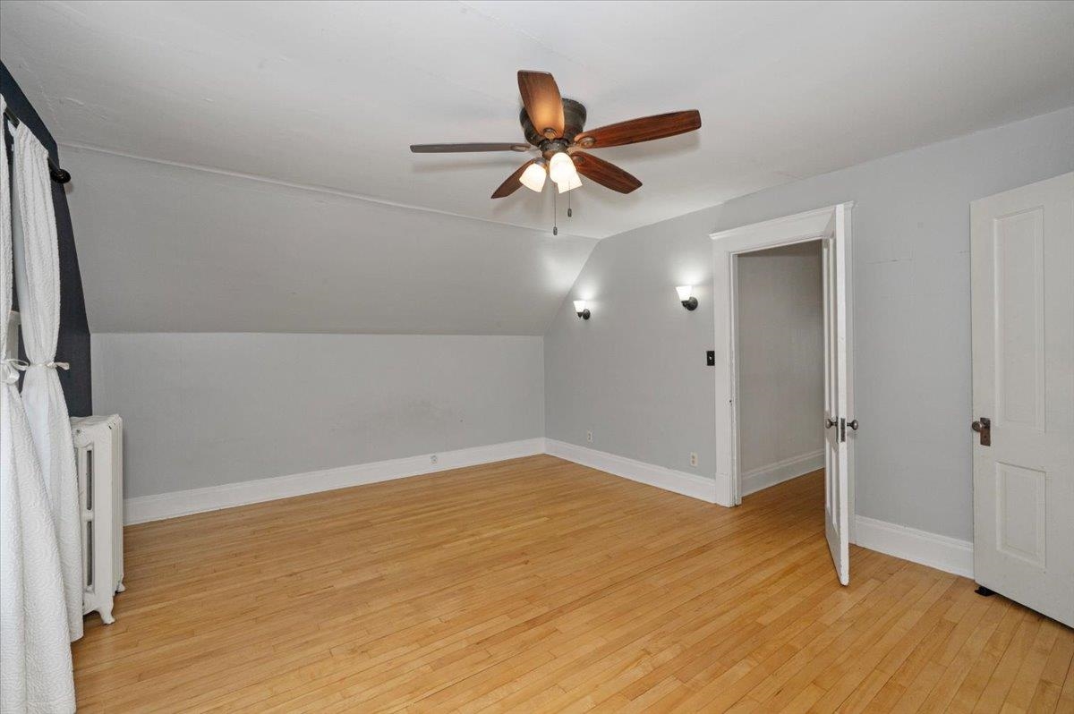 2127 Tower Avenue Superior, WI 54880 - Photo 24 of 39 Bonus room with radiator, ceiling fan, light wood-style flooring, lofted ceiling, and baseboards