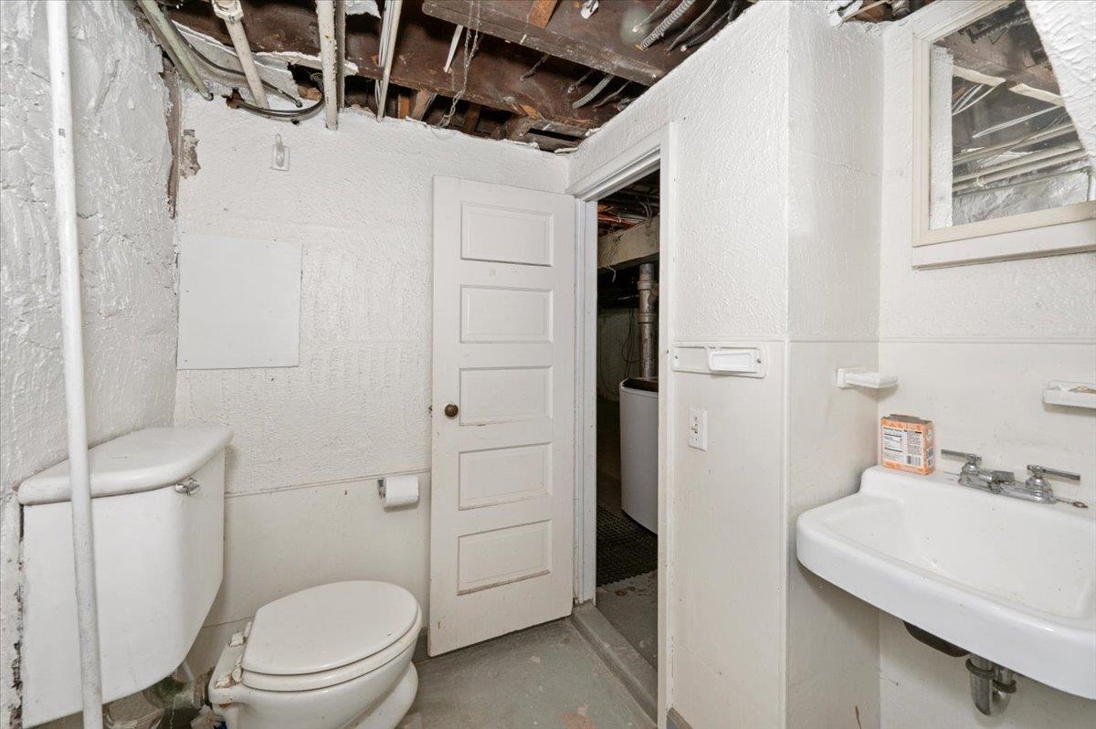 2127 Tower Avenue Superior, WI 54880 - Photo 28 of 39 Half bathroom featuring toilet, a sink, and unfinished concrete floors