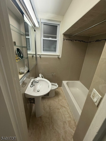 751 East 25th Street, Unit 2 Paterson, NJ 07504 - Photo 7 of 8 a bathroom with a sink a toilet and mirror