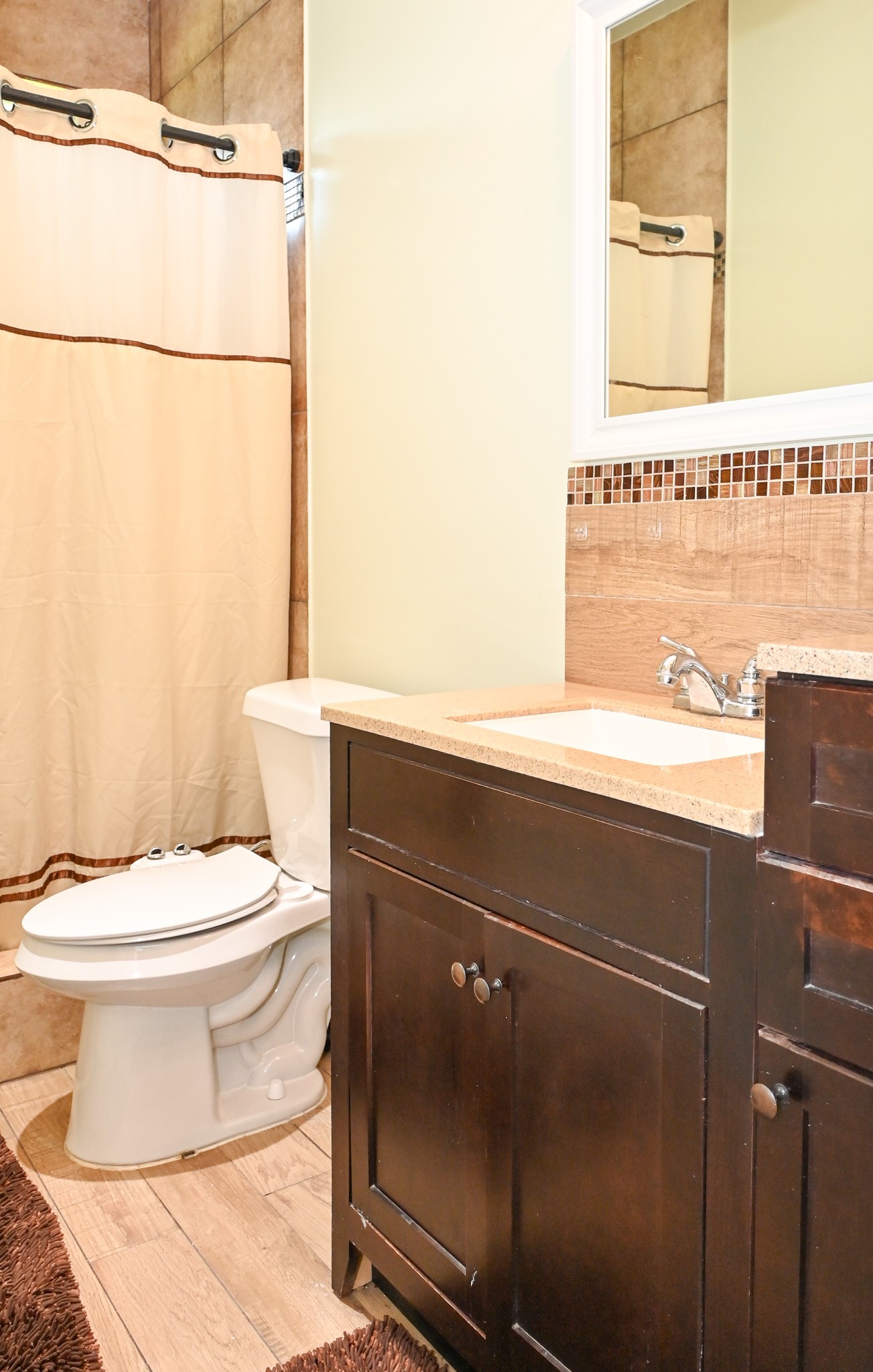 1229 County Road 2209N Cleveland, TX 77327 - Photo 30 of 43 a bathroom with a toilet a sink and mirror