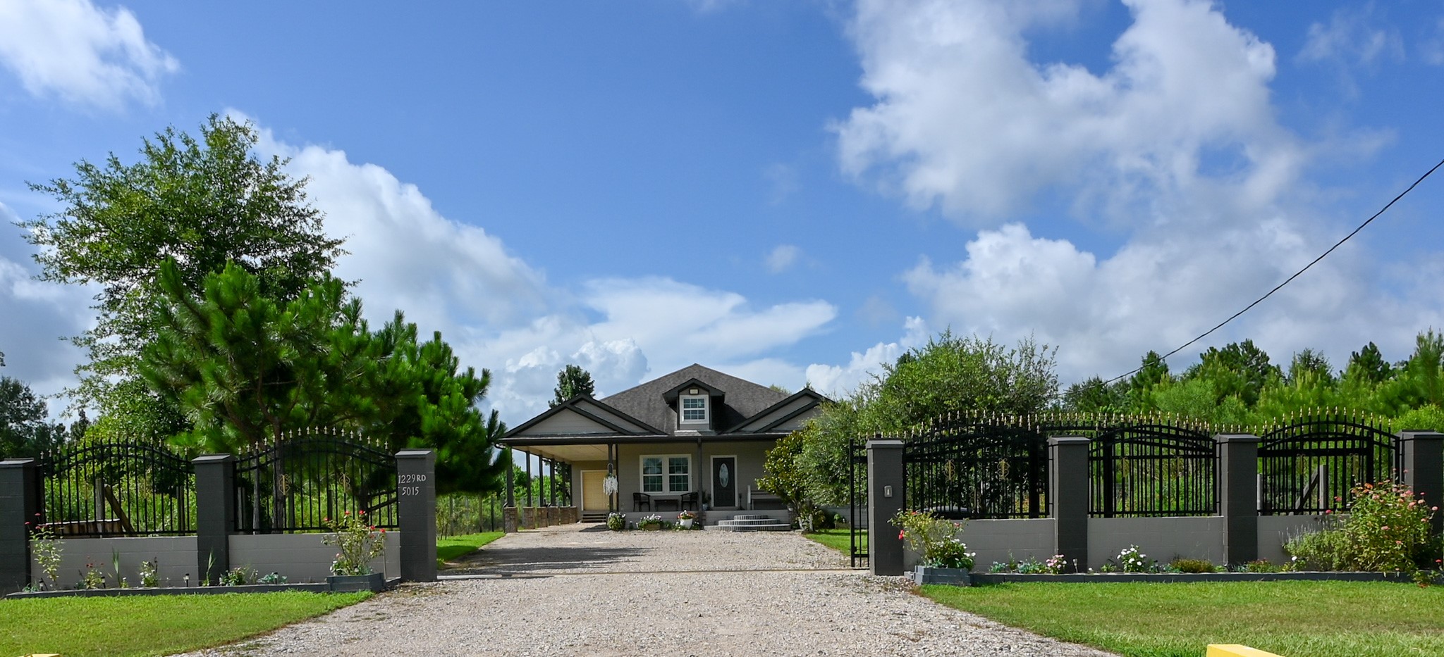 1229 County Road 2209N Cleveland, TX 77327 - Photo 3 of 43 a front view of a house with garden