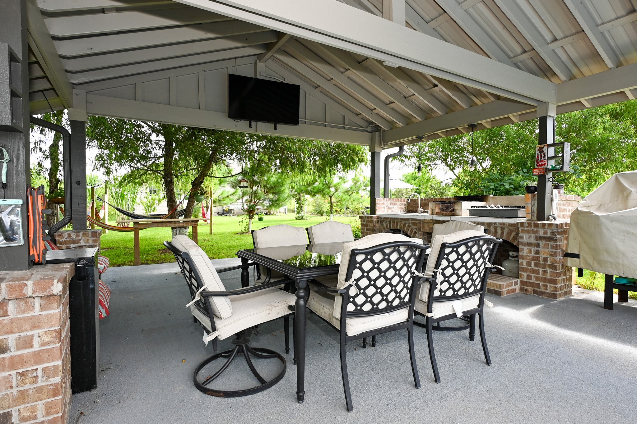 1229 County Road 2209N Cleveland, TX 77327 - Photo 42 of 43 a view of a patio with table and chairs and potted plants