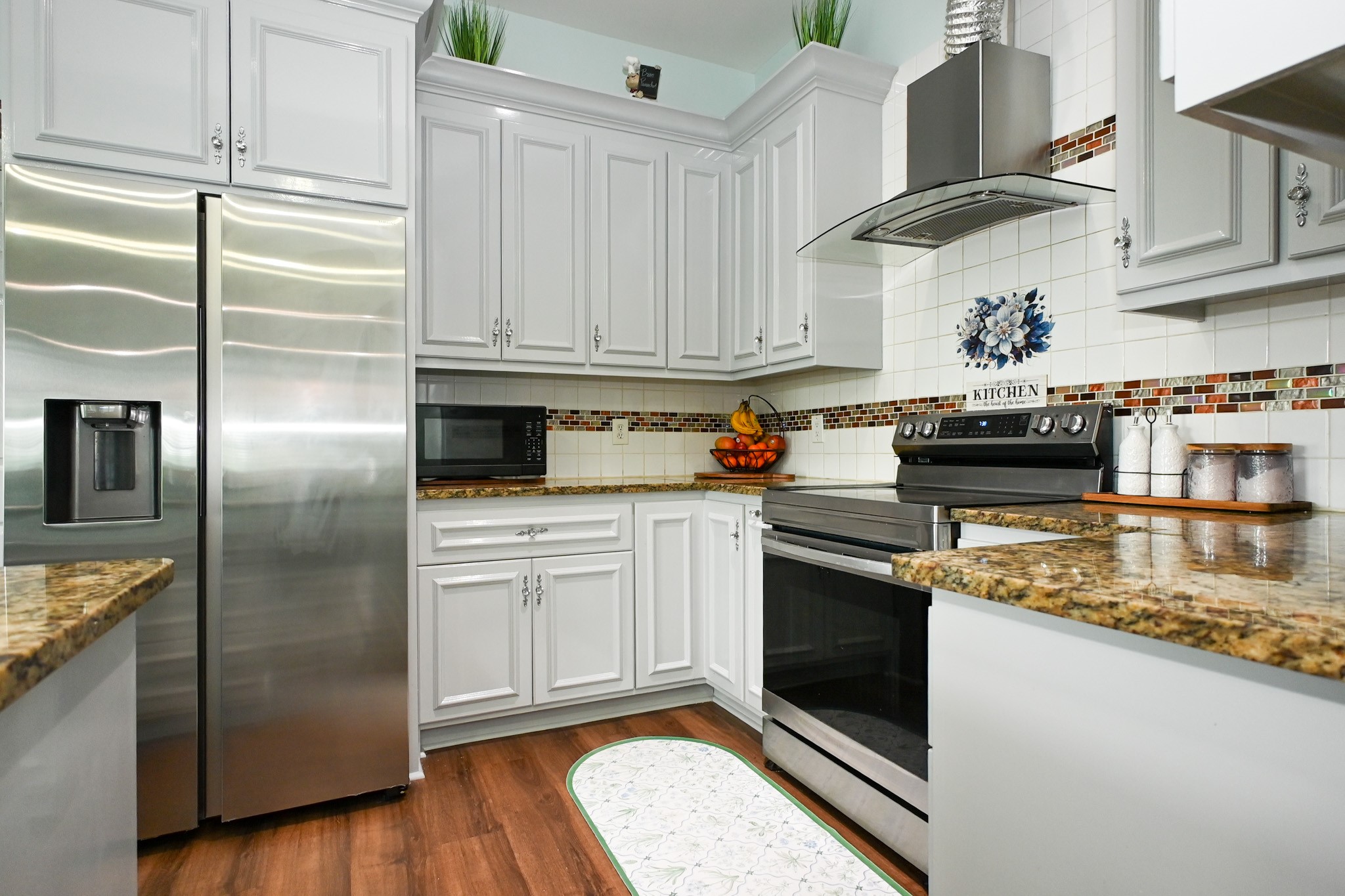 1229 County Road 2209N Cleveland, TX 77327 - Photo 5 of 43 a kitchen with granite countertop stainless steel appliances and wooden cabinets