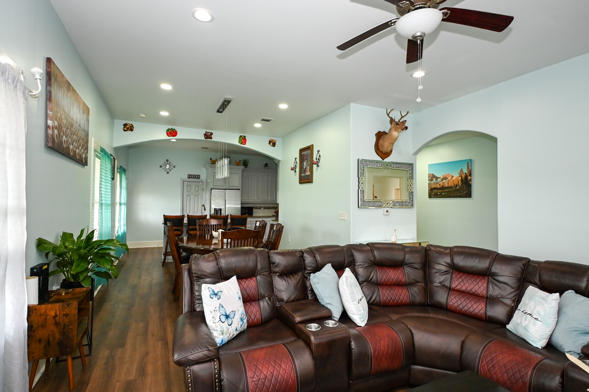 1229 County Road 2209N Cleveland, TX 77327 - Photo 9 of 43 a living room with furniture flowers and a chandelier