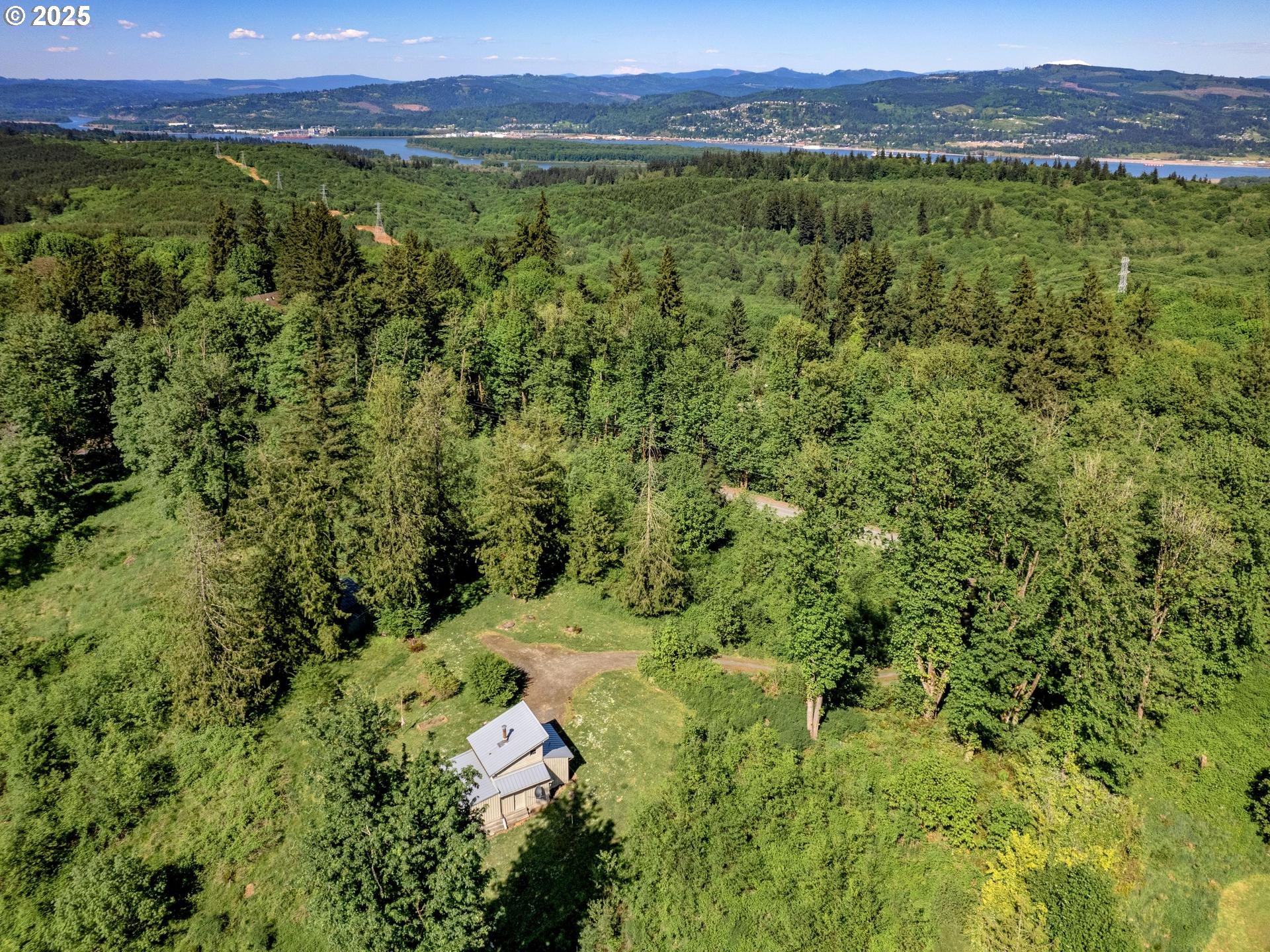 Highland Road Rainier, OR 97048 - Photo 5 of 9 a view of a lush green outdoor space with a lake view
