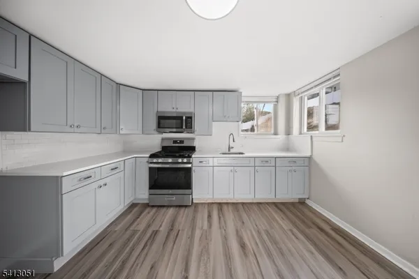 a kitchen with granite countertop white cabinets and white appliances