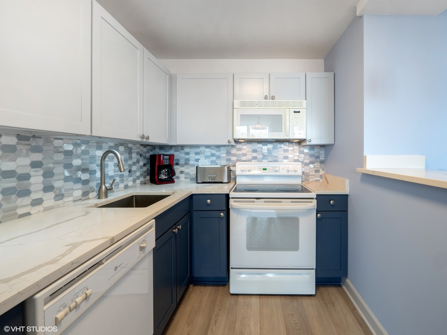655 West Irving Park Road, Unit 1006 Chicago, IL 60613 - Photo 12 of 22 a kitchen with a sink stove and cabinets