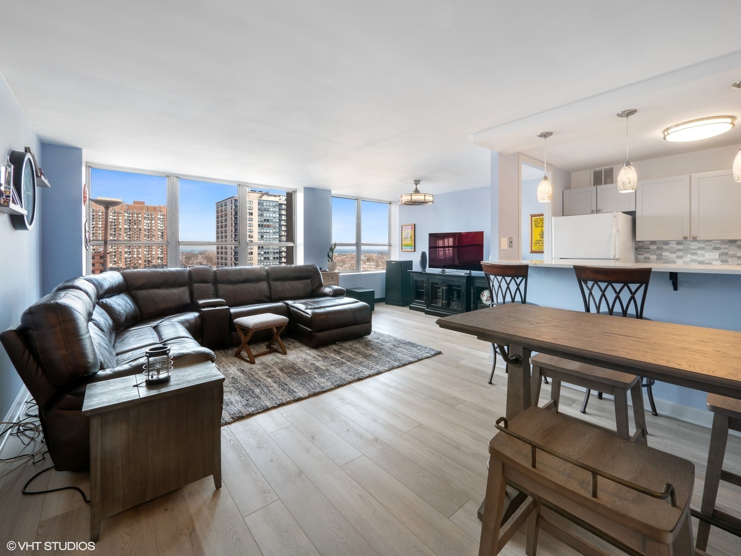 655 West Irving Park Road, Unit 1006 Chicago, IL 60613 - Photo 5 of 22 a living room with furniture and a wooden floor