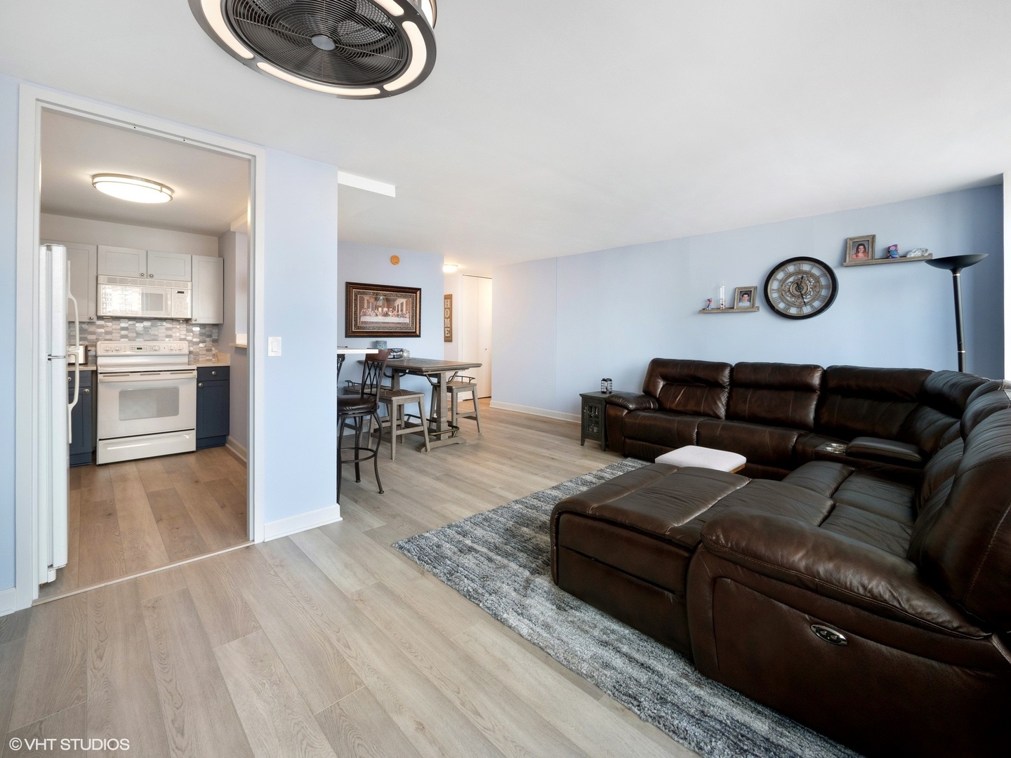 655 West Irving Park Road, Unit 1006 Chicago, IL 60613 - Photo 7 of 22 a living room with furniture and a wooden floor