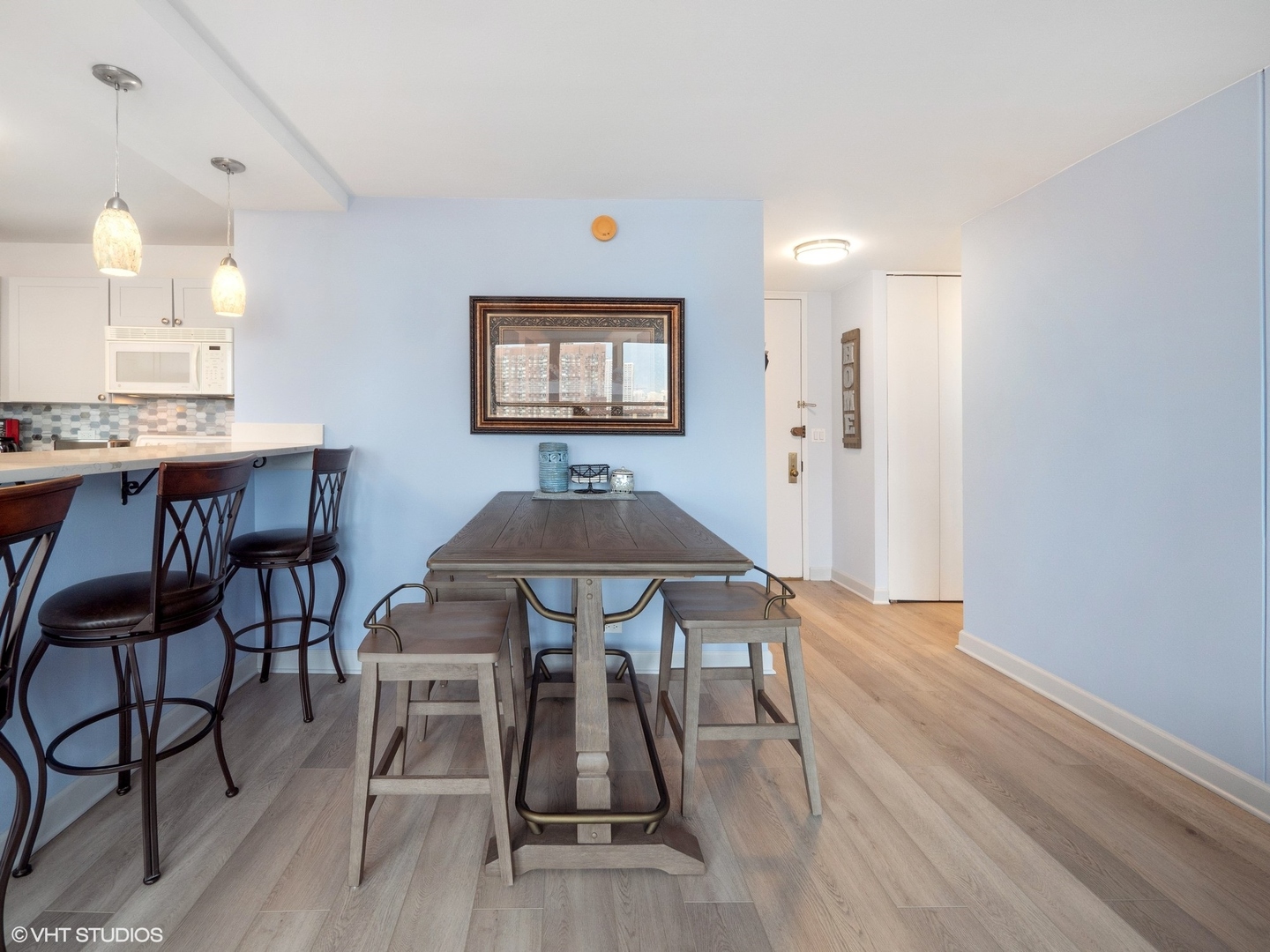 655 West Irving Park Road, Unit 1006 Chicago, IL 60613 - Photo 9 of 22 a view of a dining room with furniture and wooden floor