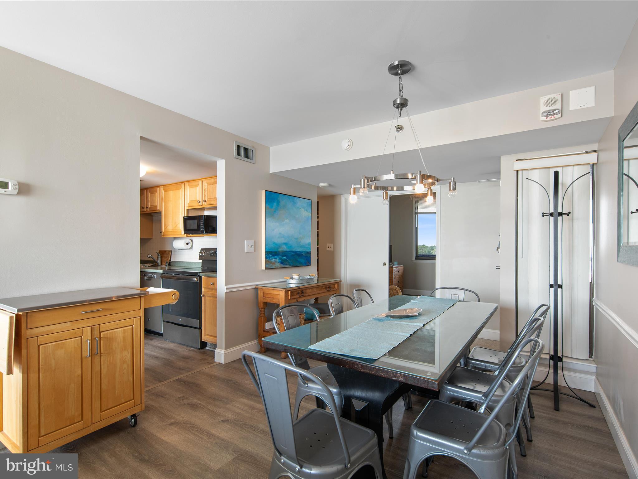 Ph03 Ph03 Farragut House Road, Unit PH03 Bethany Beach, DE 19930 - Photo 11 of 45 a view of a dining room with furniture and wooden floor