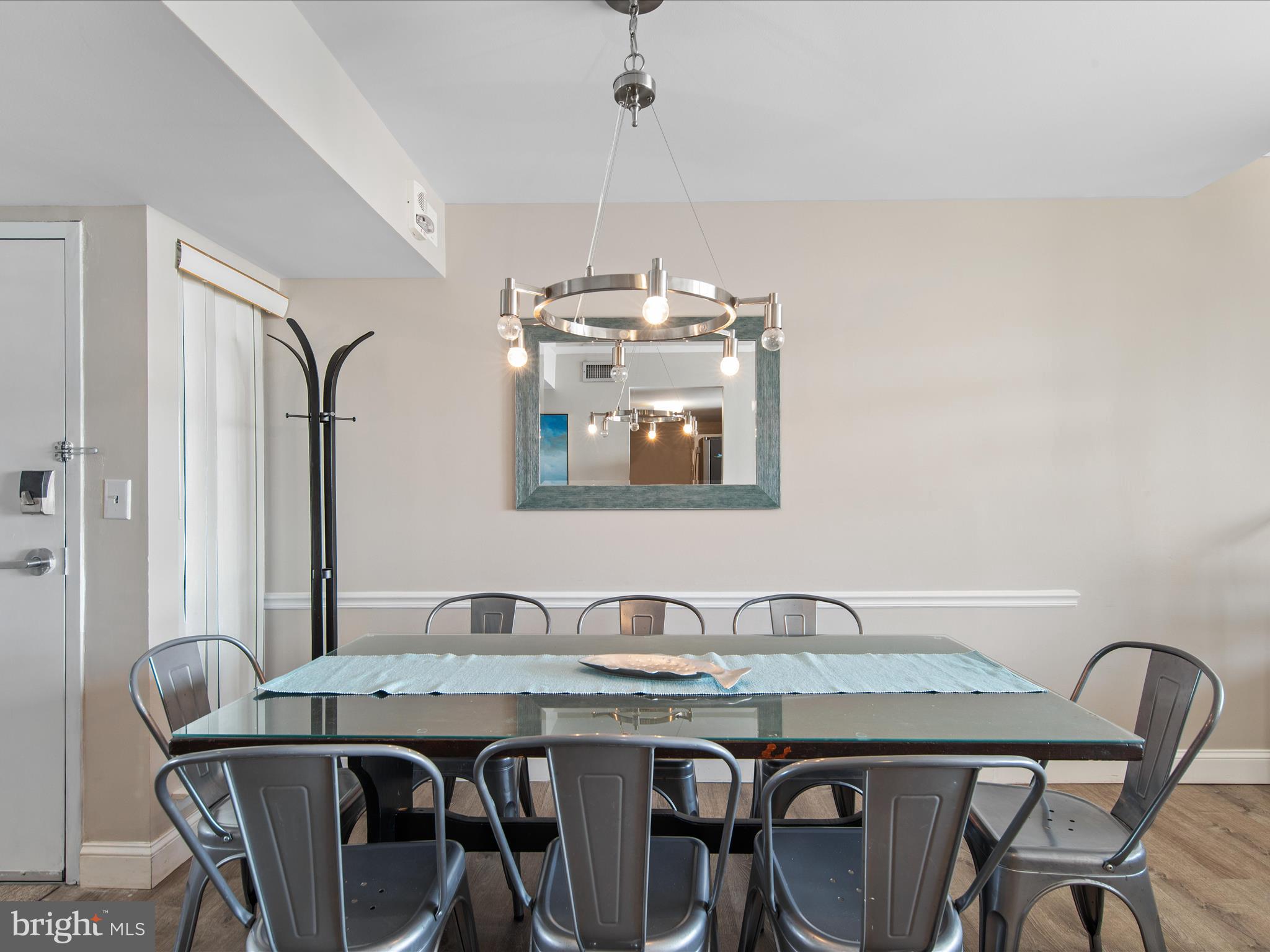 Ph03 Ph03 Farragut House Road, Unit PH03 Bethany Beach, DE 19930 - Photo 12 of 45 a dining room with a table and chairs