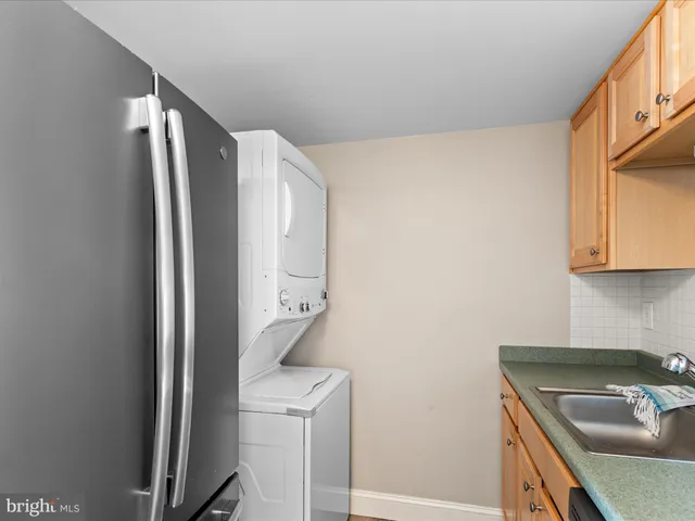 a kitchen with stainless steel appliances granite countertop a sink a stove and cabinets