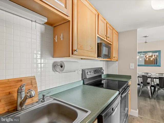 a kitchen with granite countertop a stove and a microwave