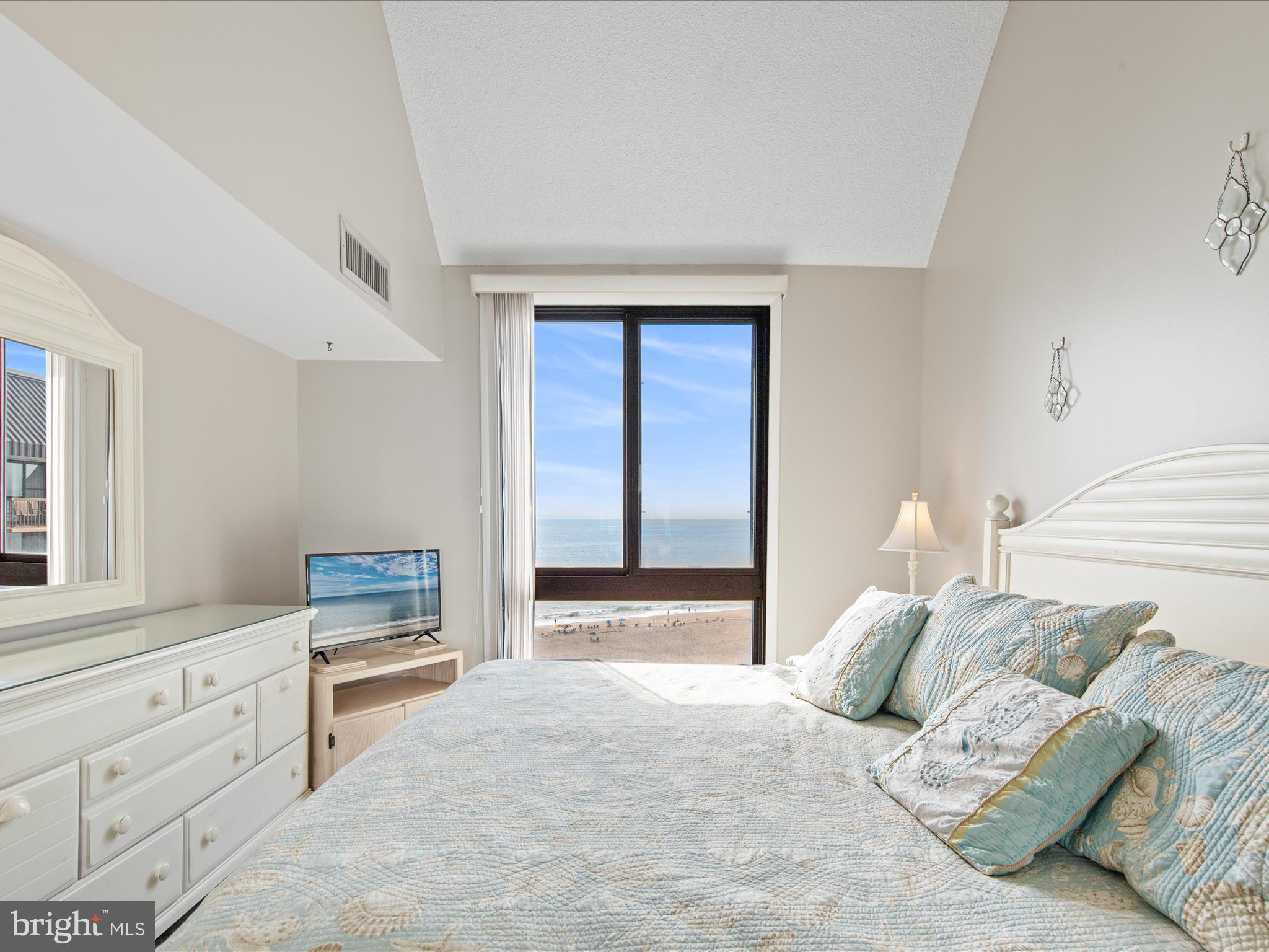 Ph03 Ph03 Farragut House Road, Unit PH03 Bethany Beach, DE 19930 - Photo 24 of 45 a bedroom with a bed and a window