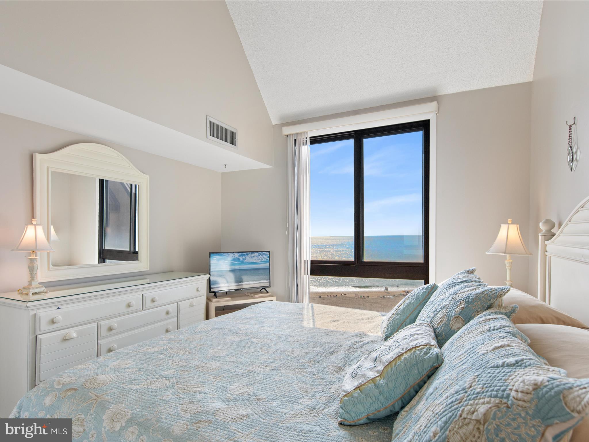 Ph03 Ph03 Farragut House Road, Unit PH03 Bethany Beach, DE 19930 - Photo 26 of 45 a bedroom with a bed and a chair