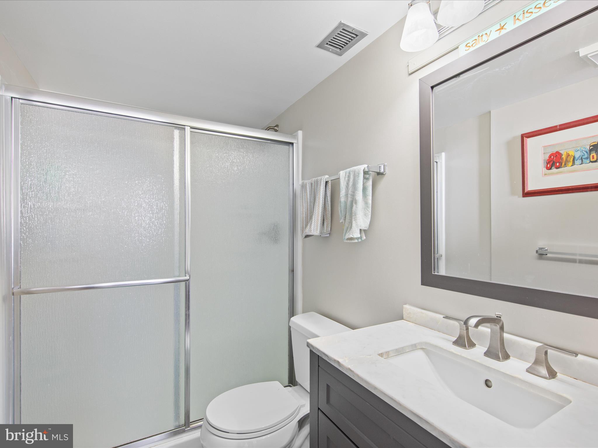 Ph03 Ph03 Farragut House Road, Unit PH03 Bethany Beach, DE 19930 - Photo 29 of 45 a bathroom with a sink toilet and shower