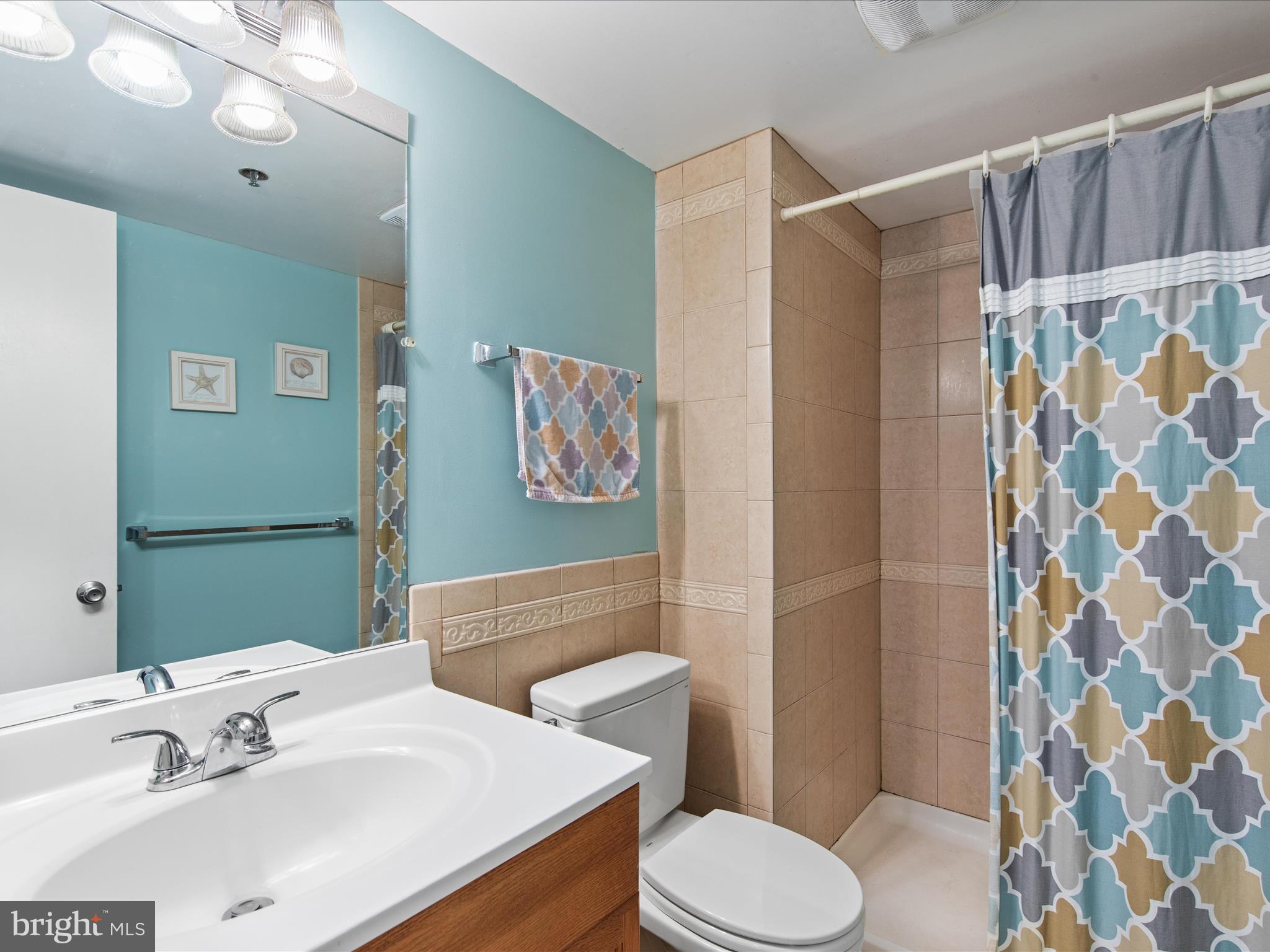 Ph03 Ph03 Farragut House Road, Unit PH03 Bethany Beach, DE 19930 - Photo 34 of 45 a bathroom with a sink toilet and shower