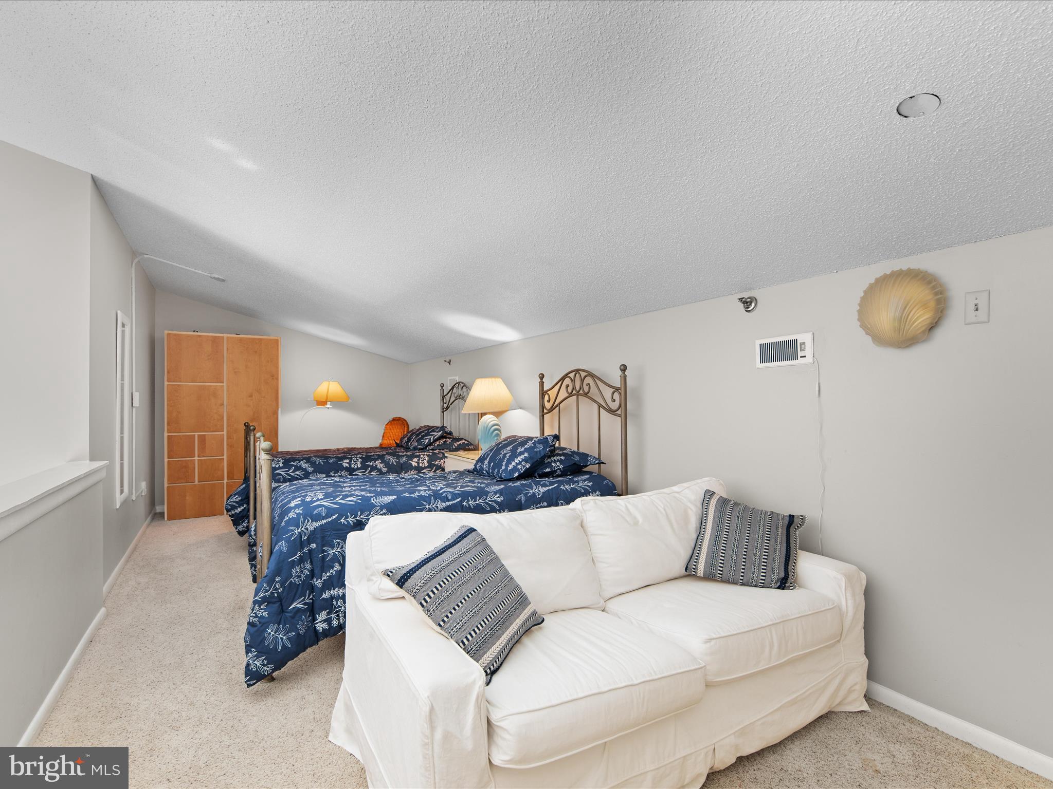 Ph03 Ph03 Farragut House Road, Unit PH03 Bethany Beach, DE 19930 - Photo 35 of 45 a living room with furniture and a fireplace