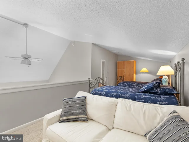 a bedroom with a large bed and a dresser