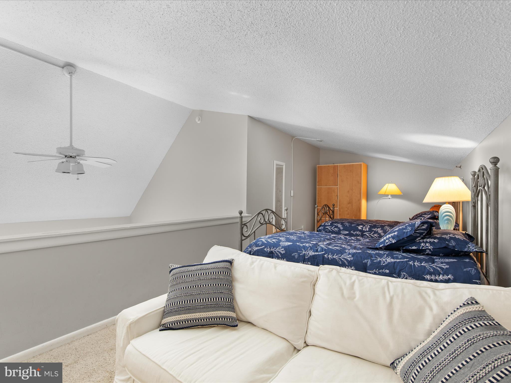 Ph03 Ph03 Farragut House Road, Unit PH03 Bethany Beach, DE 19930 - Photo 36 of 45 a living room with furniture and a fireplace