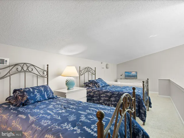 a bed room with a bed and a lamp