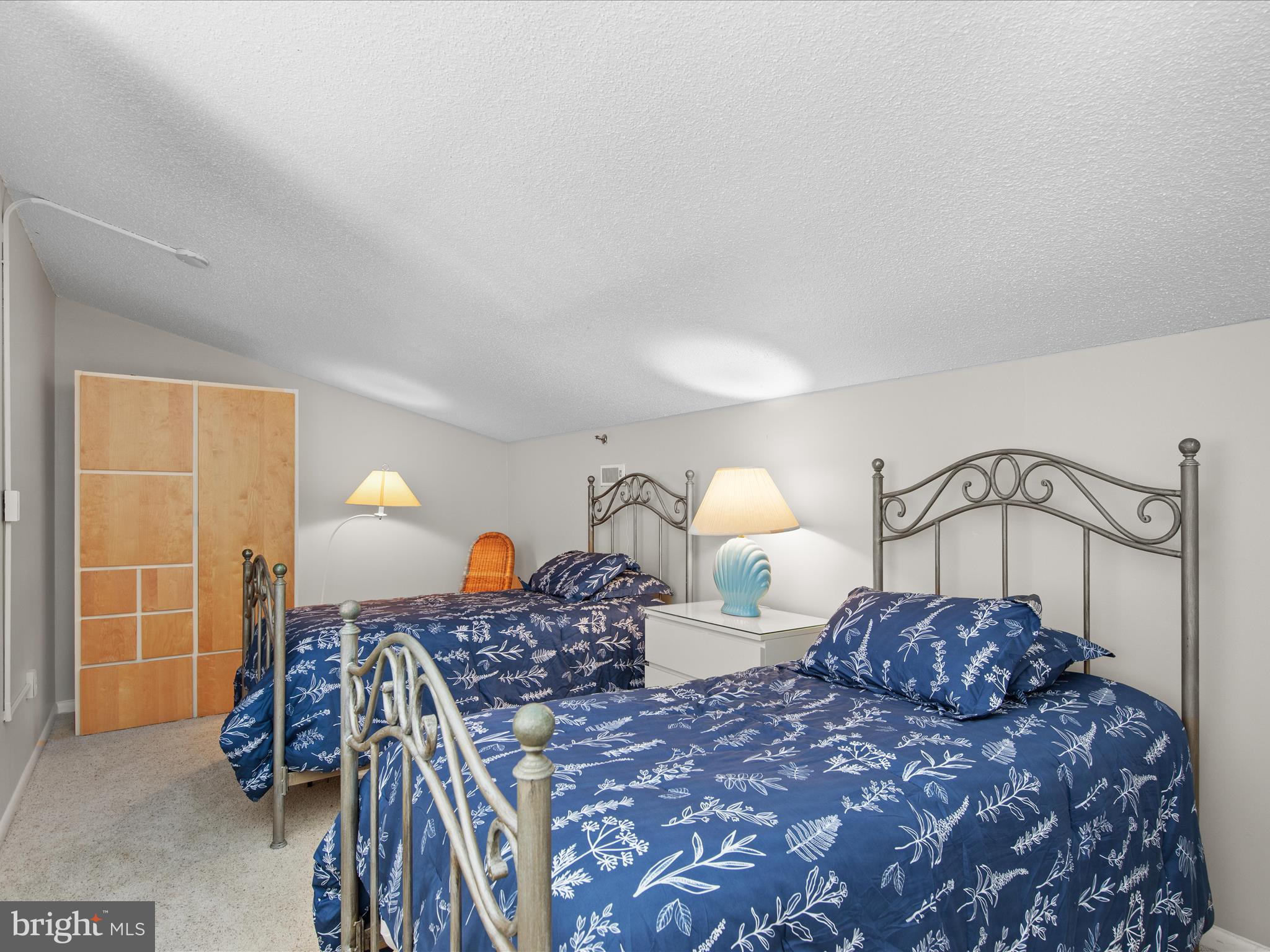 Ph03 Ph03 Farragut House Road, Unit PH03 Bethany Beach, DE 19930 - Photo 38 of 45 a bed room with a bed and a lamp