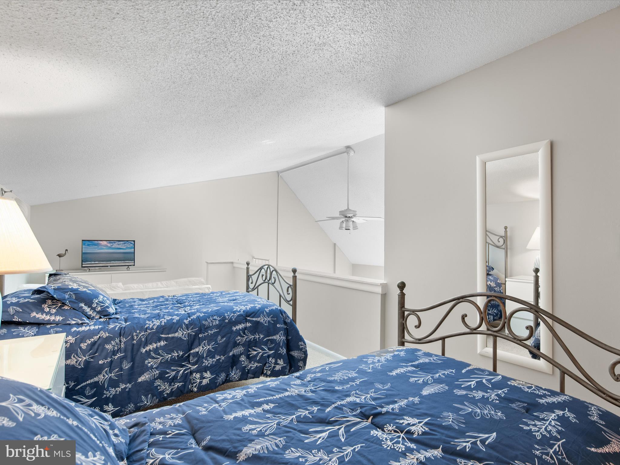 Ph03 Ph03 Farragut House Road, Unit PH03 Bethany Beach, DE 19930 - Photo 39 of 45 a bedroom with a large bed and mirror on the dresser