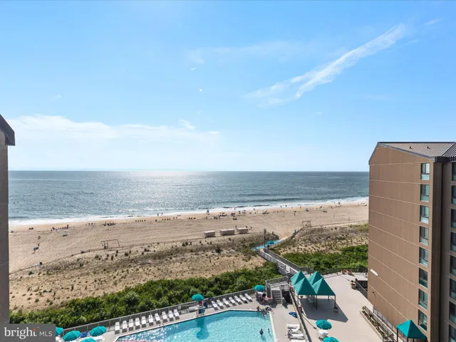 a view of roof deck with wooden floor and fence