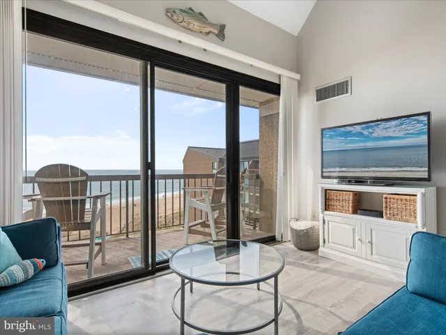 a living room with furniture flat screen tv and a fireplace