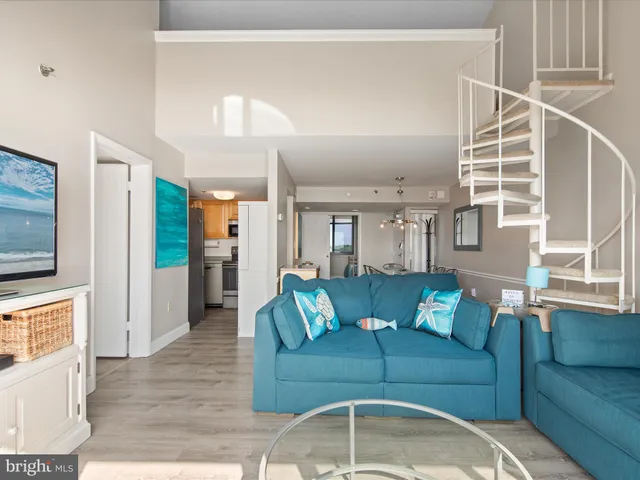 a view of living room with furniture and a floor to ceiling window