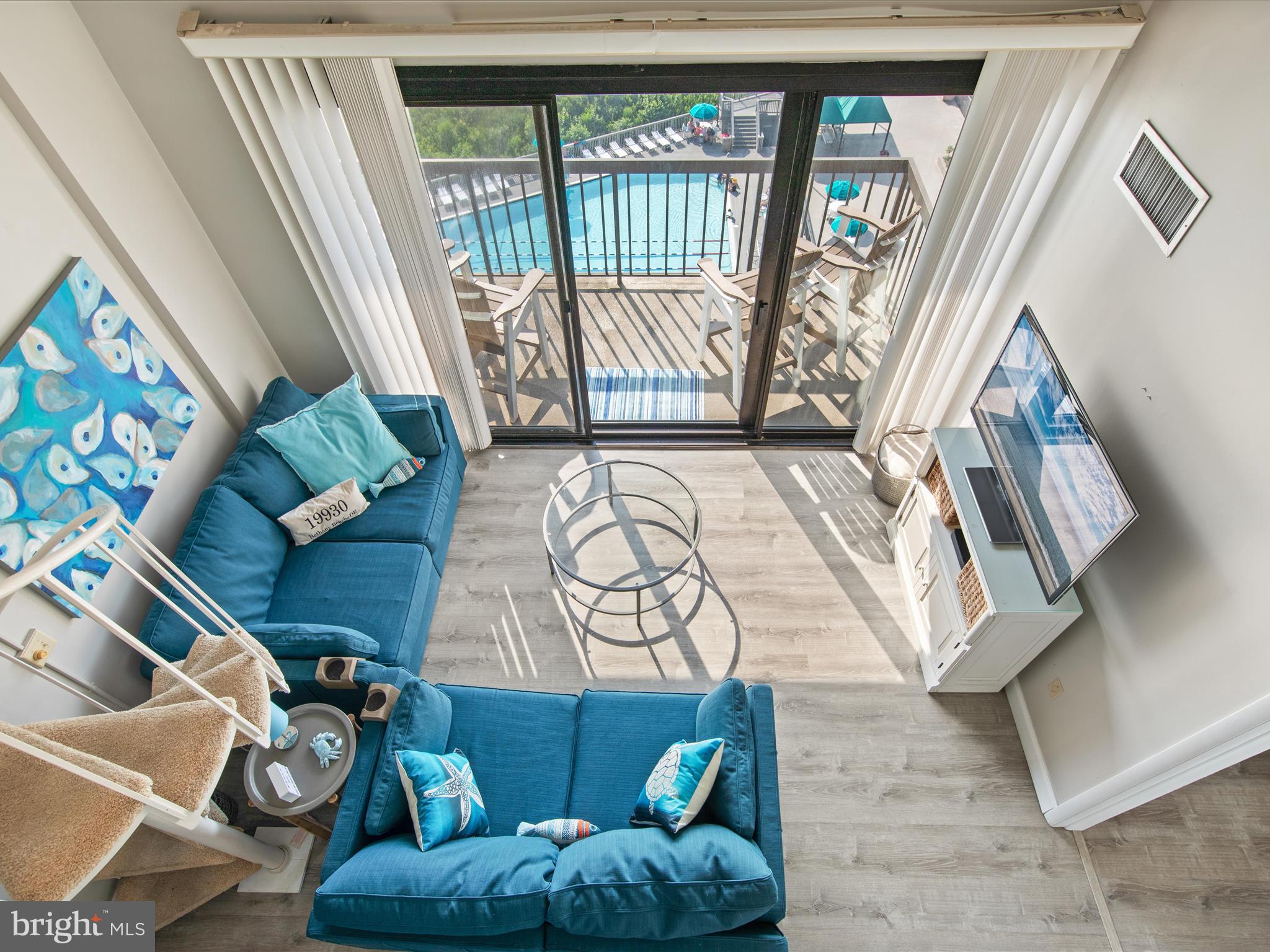Ph03 Ph03 Farragut House Road, Unit PH03 Bethany Beach, DE 19930 - Photo 9 of 45 a view of living room with furniture and a floor to ceiling window