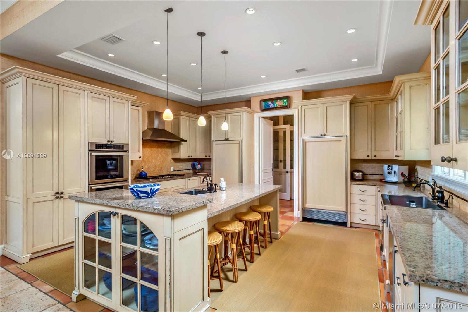 441 Island Drive Key Biscayne, FL 33149 - Photo 6 of 47 OPEN KITCHEN WITH GAS COOK TOP, WOOD CABINETS AND GRANITE COUNTERS