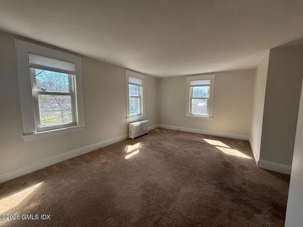 a view of kitchen space with wooden floor and electronic appliances